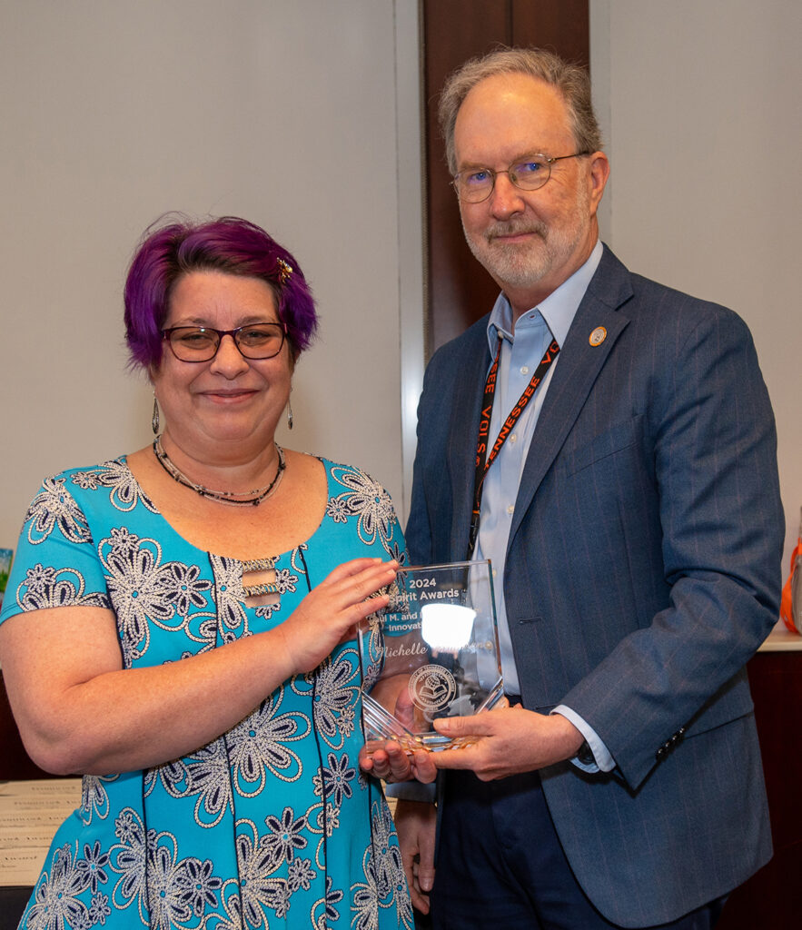 Michelle Brannen receives the Paul M. and Marion T. Miles Innovation Award from Dean of Libraries Steve Smith.