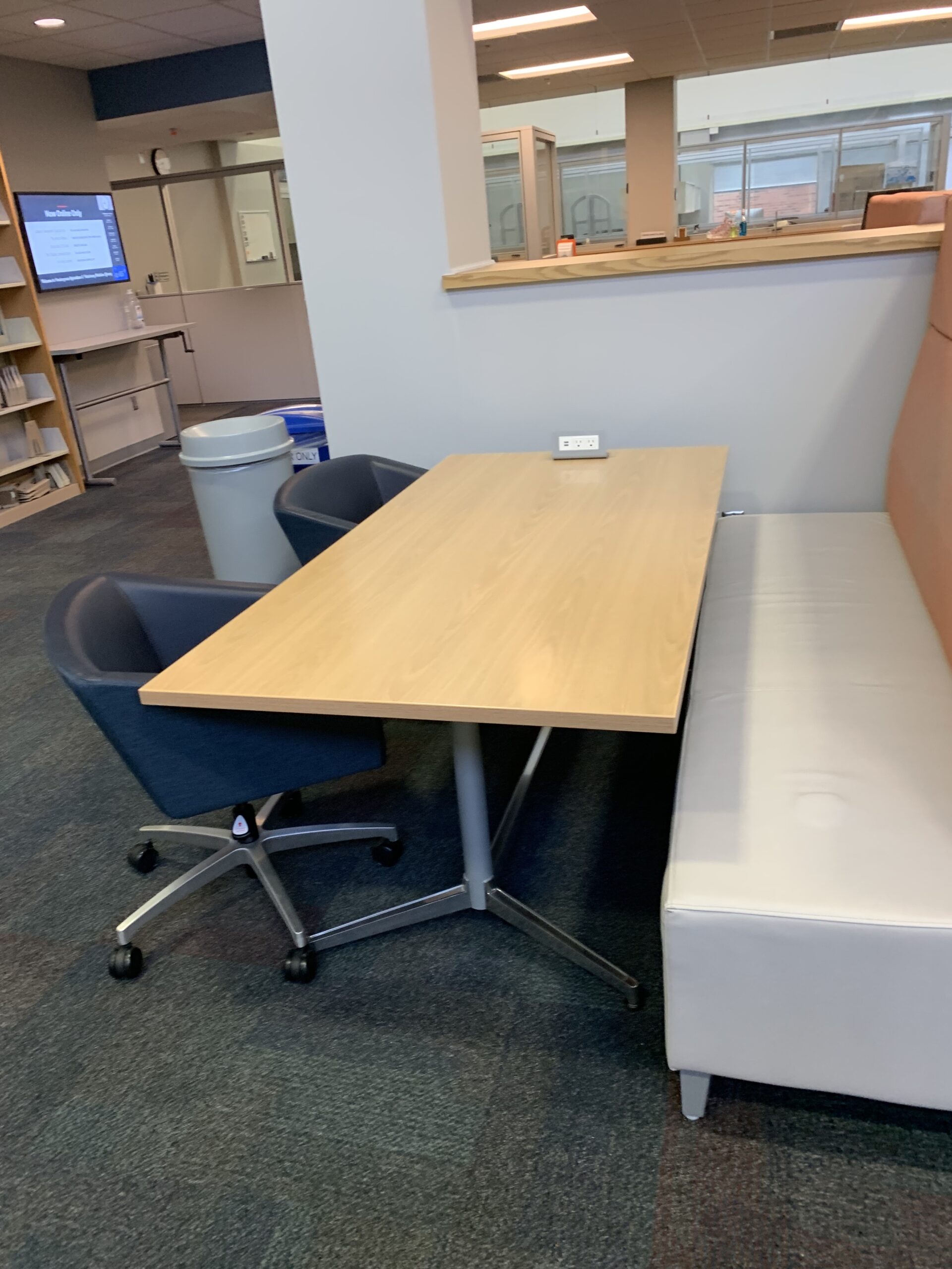 Rectangular table with lounge chairs and booth seating